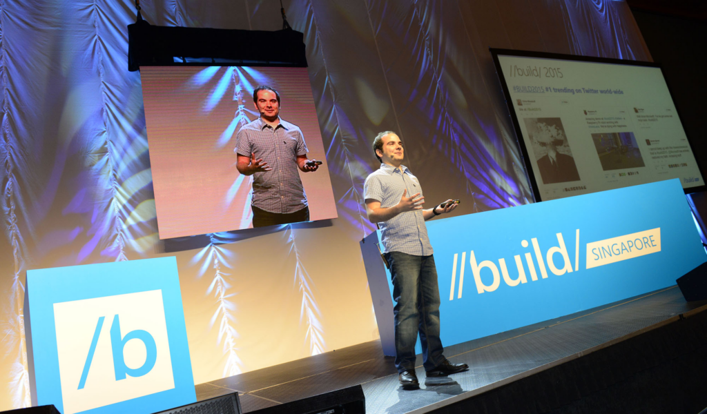 Microsoft build t alt |  giorgio sardio no palco do evento build, com logo do evento exibido em ambos os lados dele.