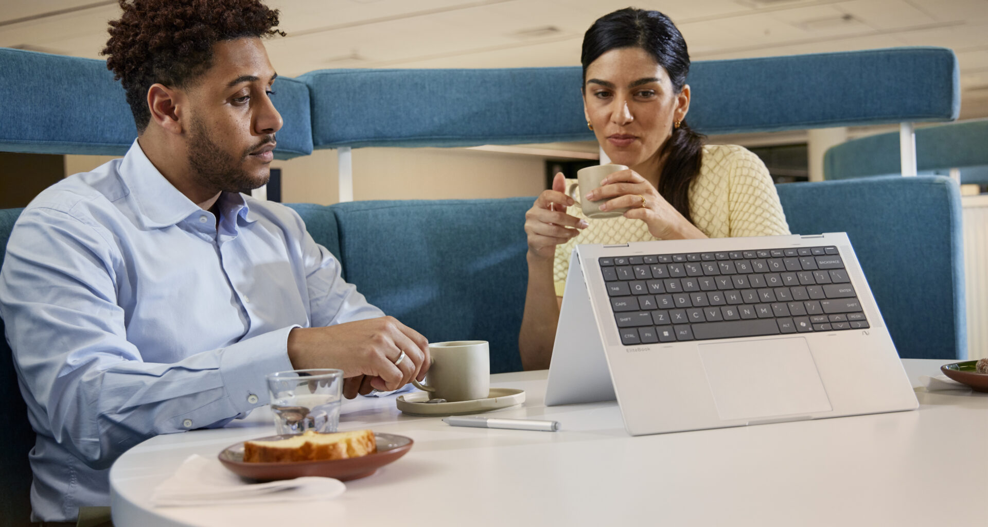 Hp elitebook x flip sendo usado por homem e mulher sobre a mesa